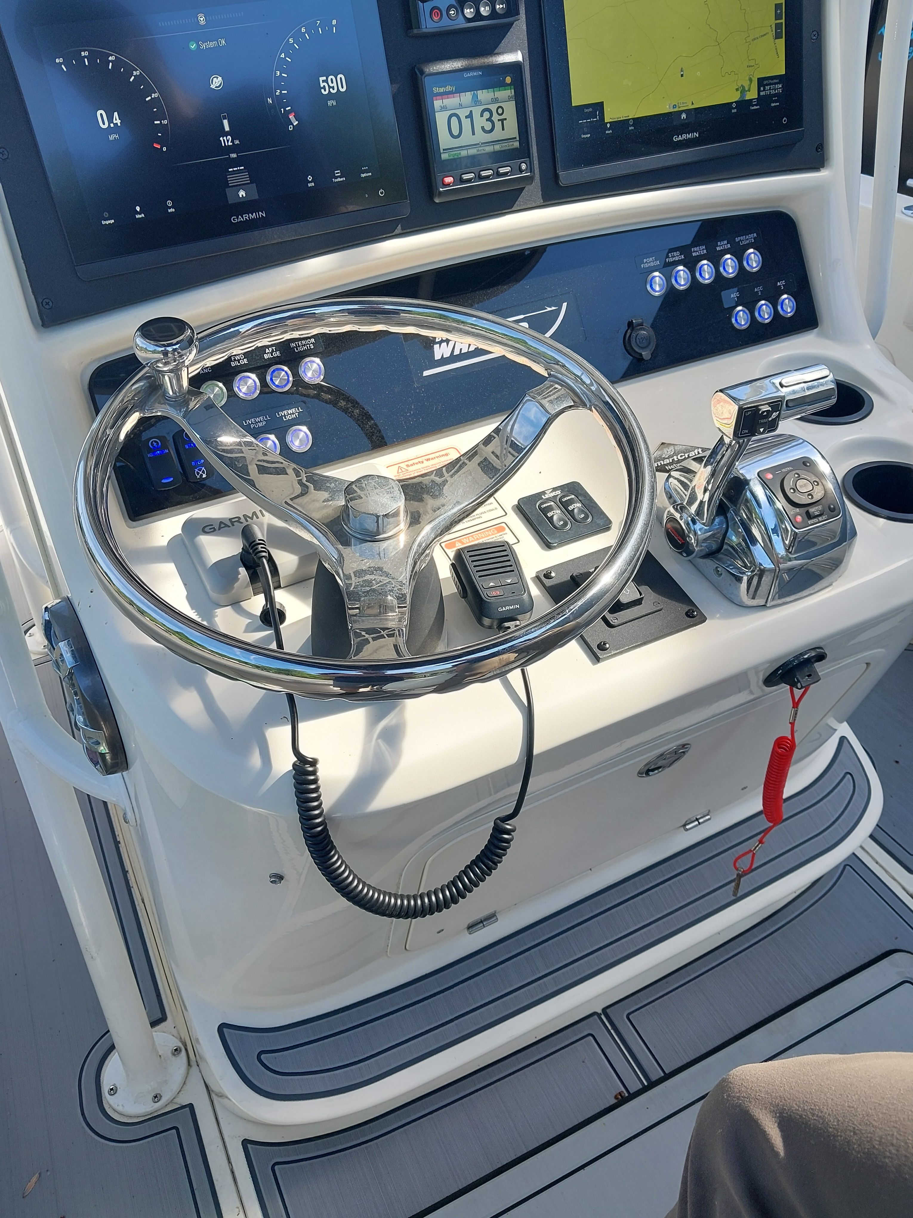 The image shows the helm of a 2005 Boston Whaler 240 Outrage with modern instruments.