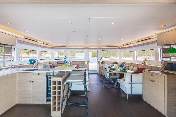 Luxurious interior of 2025 Lagoon 60 yacht with modern furnishings and panoramic windows.