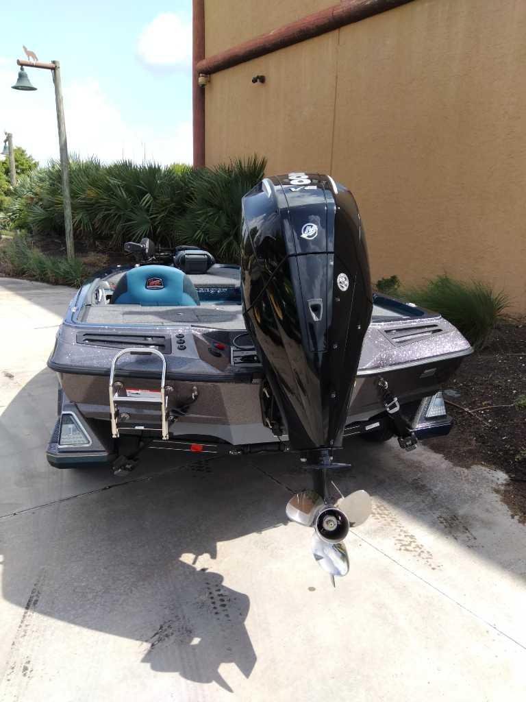 2025 Ranger Z518 boat with powerful outboard motor, parked outdoors.