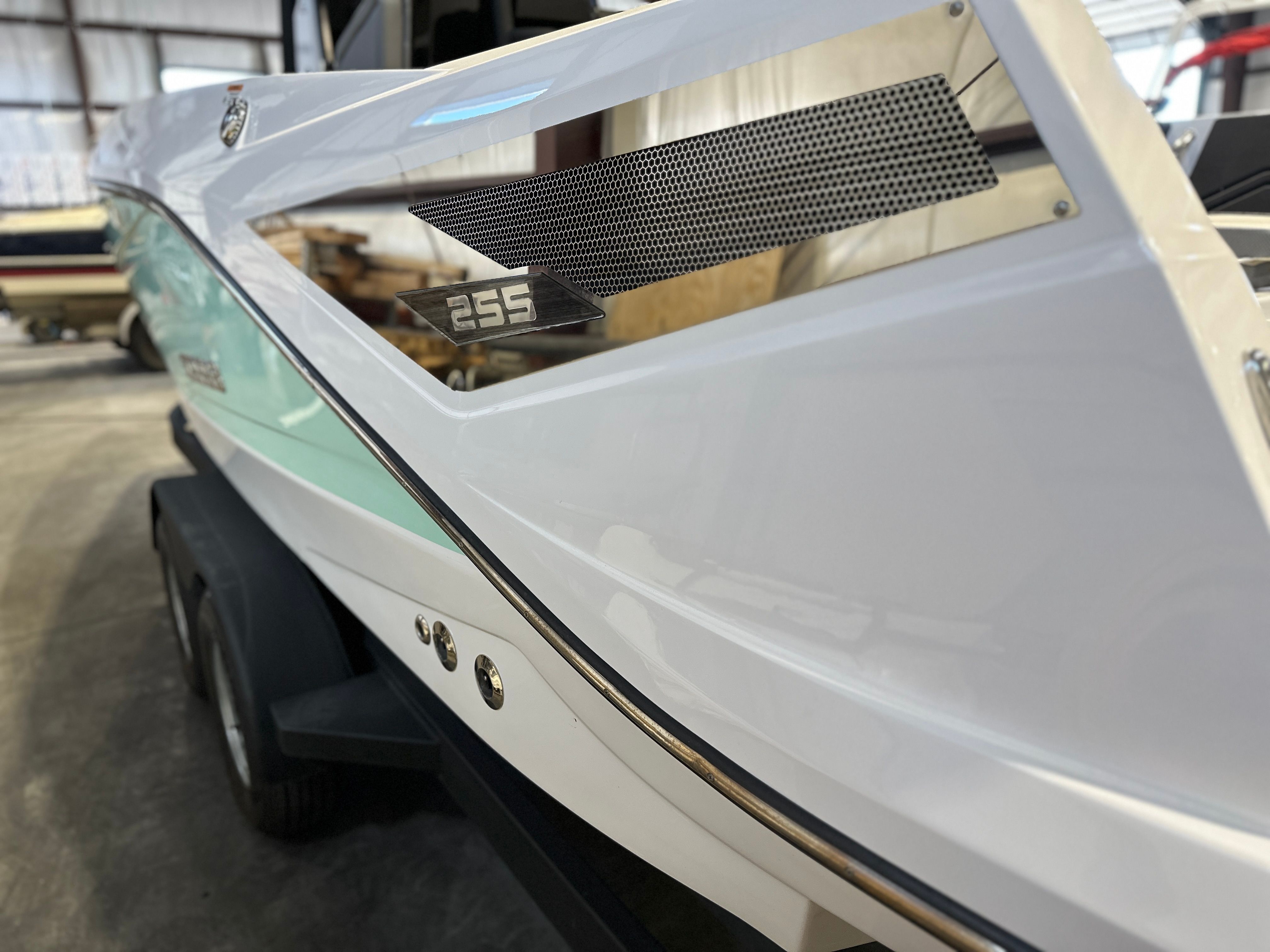 Close-up of a white 2021 Scarab 255 Open ID boat in a storage facility.