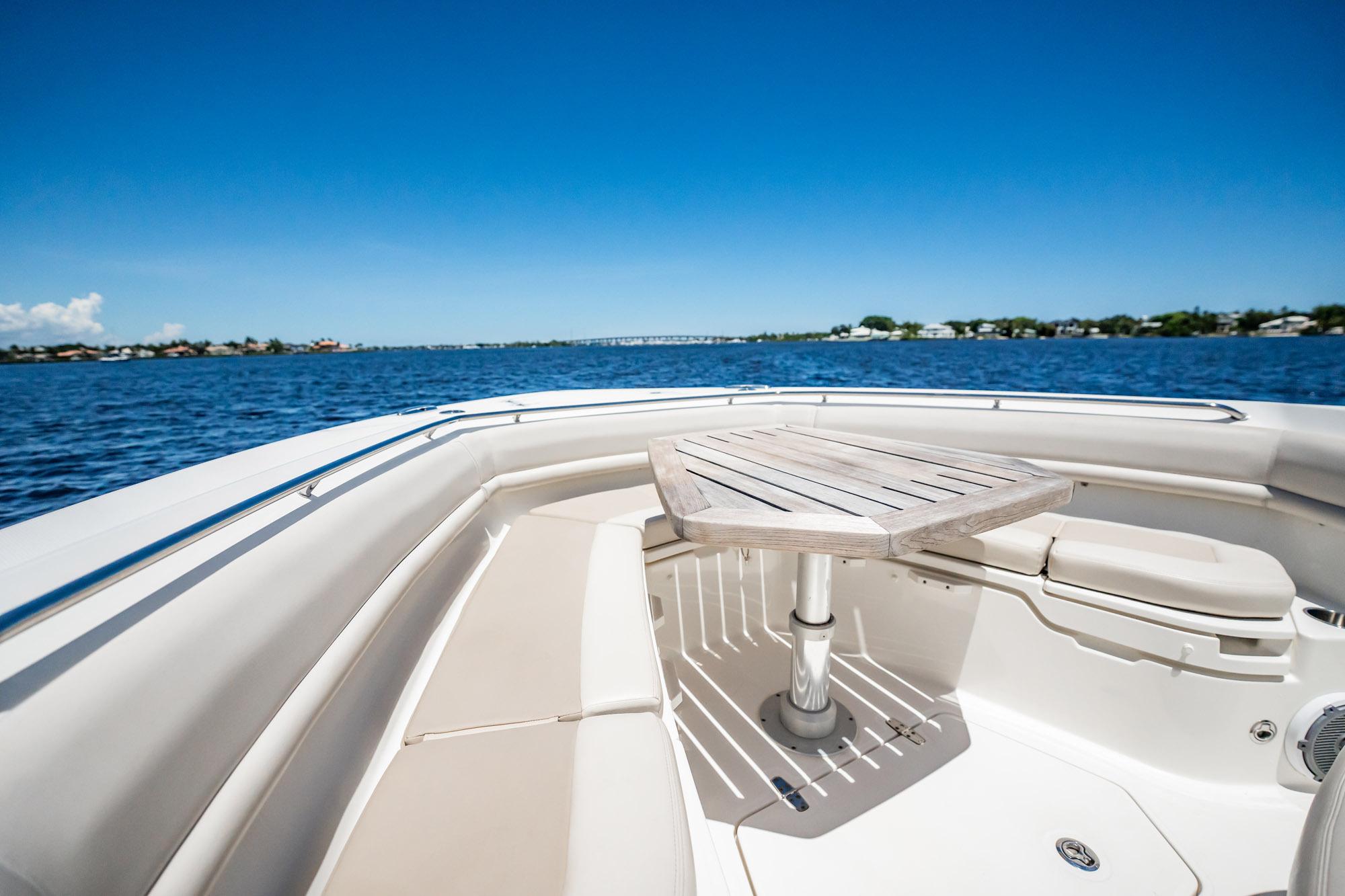 2018 Boston Whaler 380 Outrage boat interior with table on calm water.