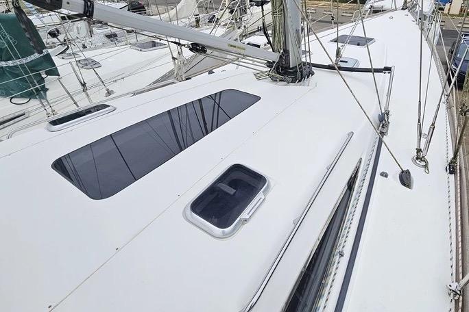 Sailboat deck of a 2010 Maxi 1300, featuring sleek design and modern fittings.
