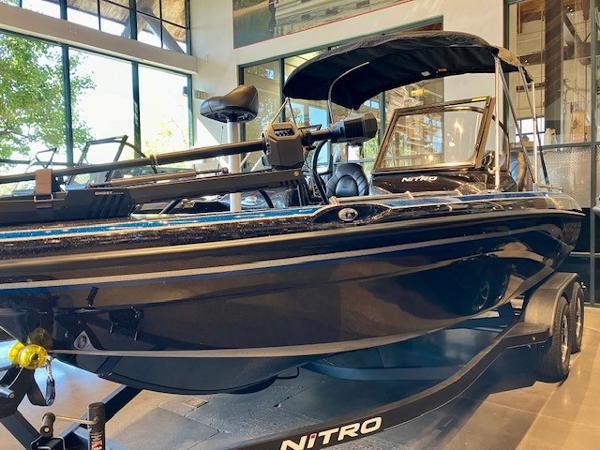 2024 Nitro ZV19 Pro boat displayed indoors, featuring sleek black design and modern equipment.