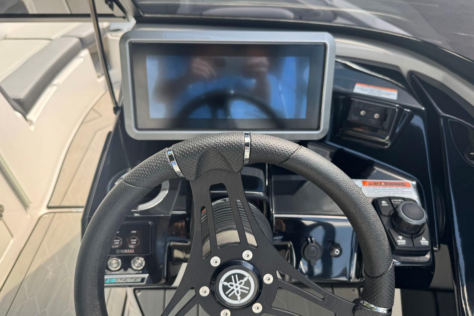 2023 Yamaha Boats 252XE dashboard with steering wheel and touchscreen display.