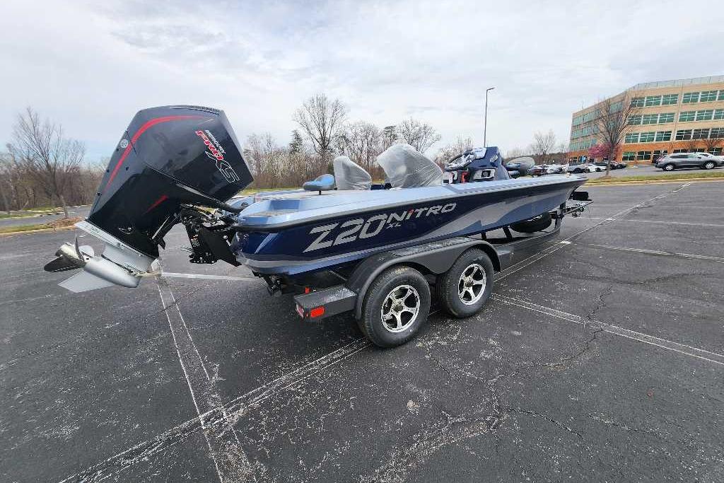 2026 Nitro Z20 XL boat on trailer in parking lot, showcasing sleek design and powerful engine.