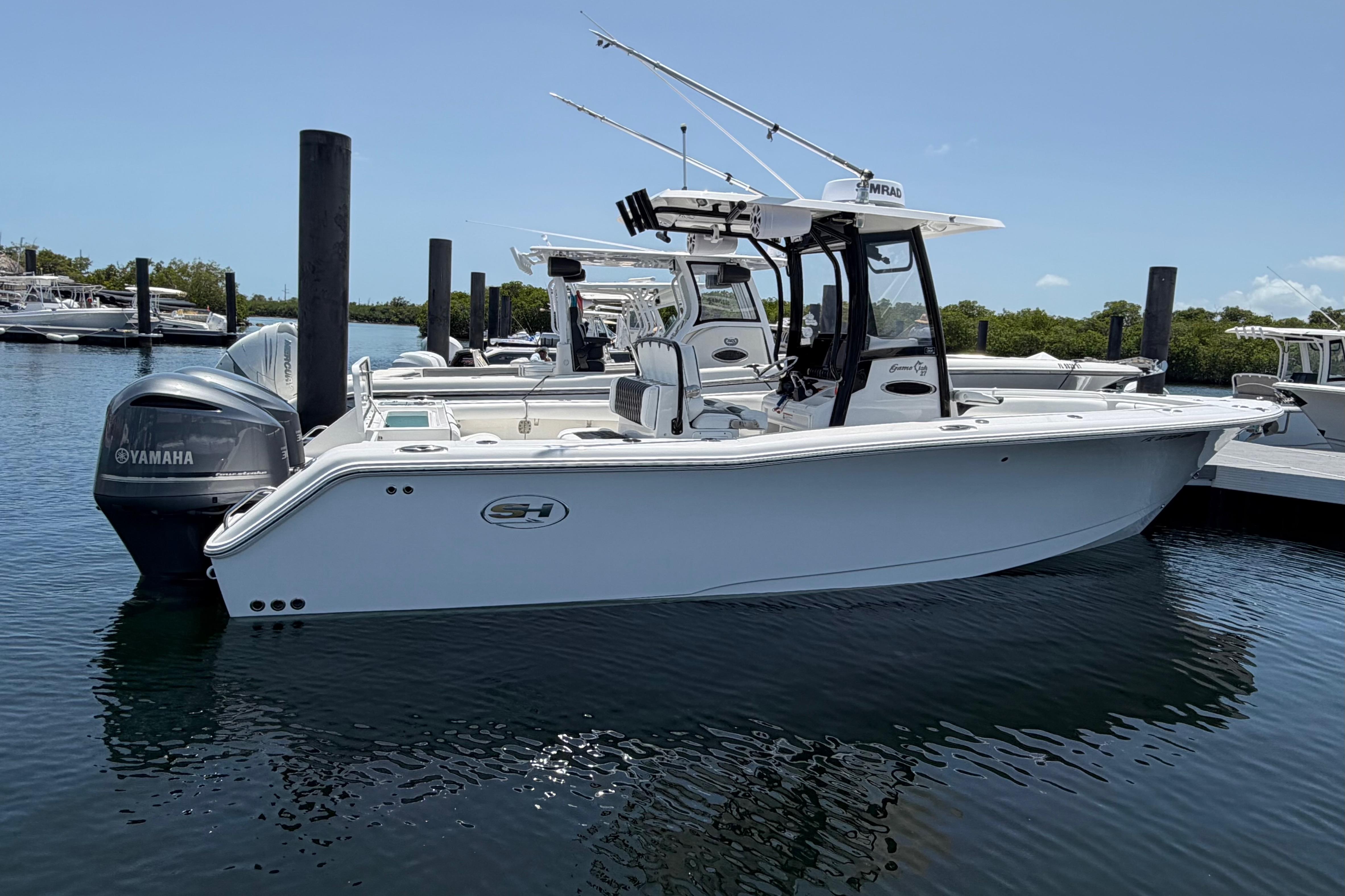 2019 Sea Hunt Gamefish 27 Coffin Box boat docked, featuring Yamaha engines.