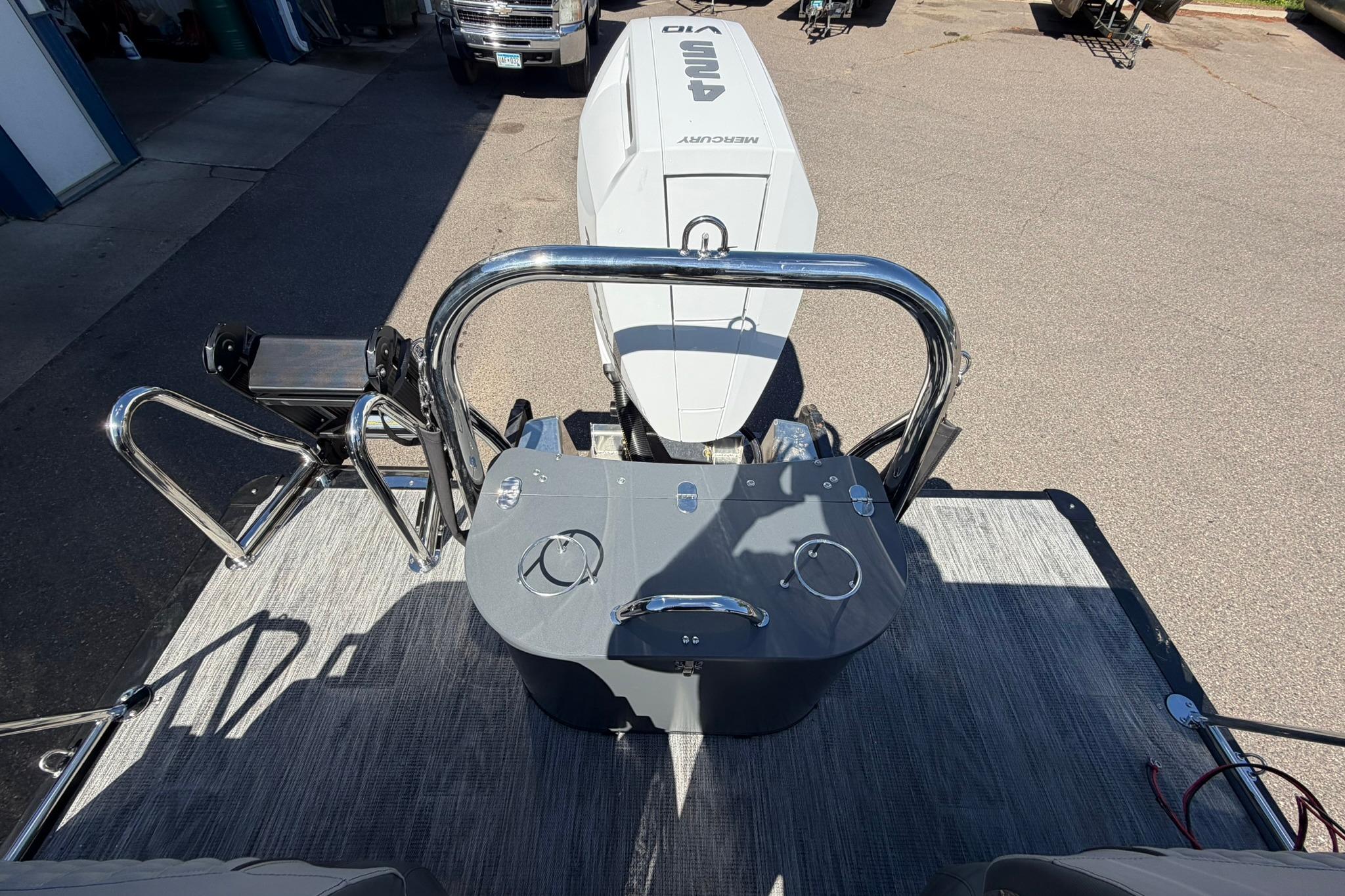 2026 Avalon Excalibur LTD Quad Lounge boat with Mercury outboard engine, rear view.