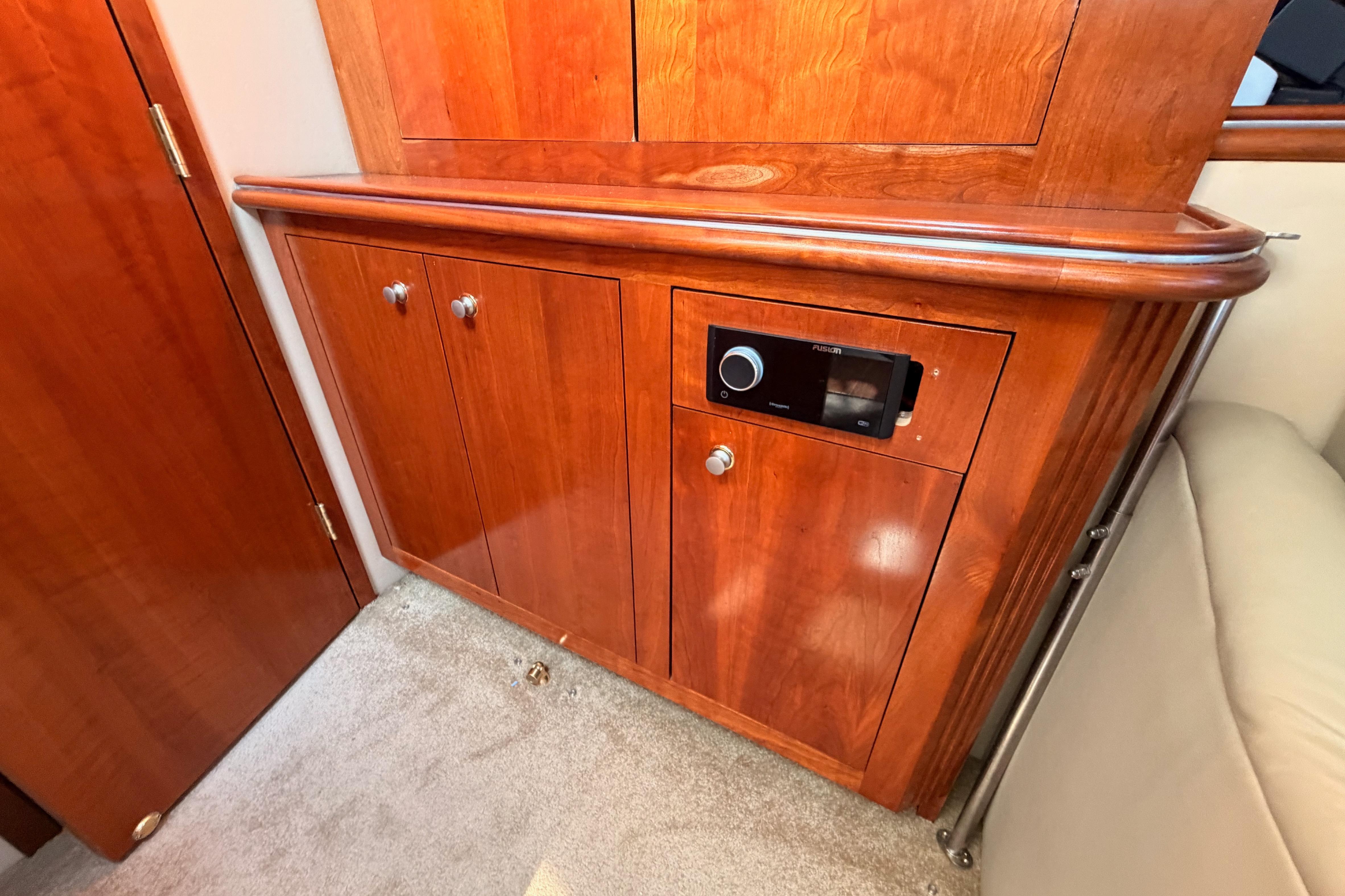 2005 Cruisers Yachts 405 Express Motoryacht interior with wooden cabinetry and stereo system.