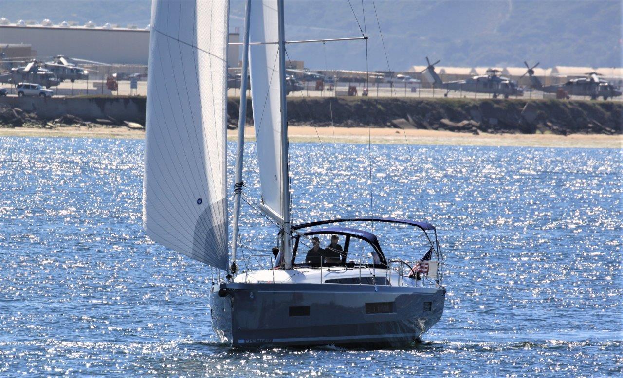 2021 Beneteau Oceanis 40.1 sailing on a sunny day near the coast.