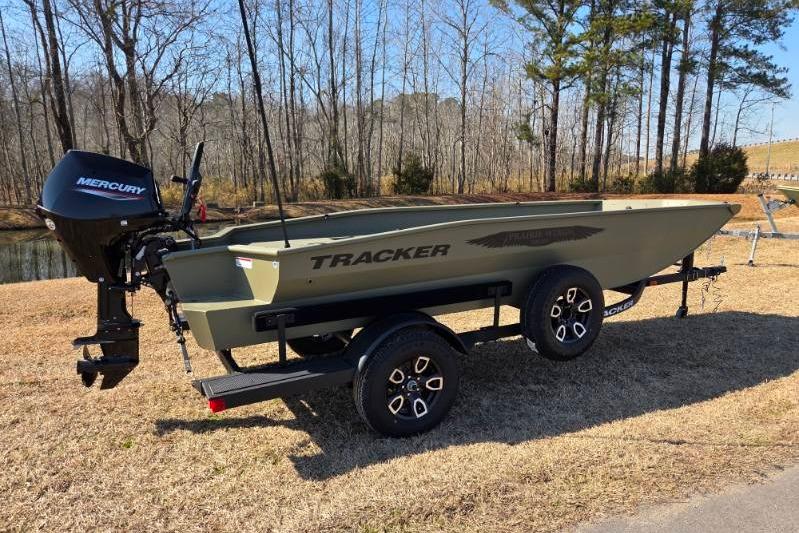 2026 Tracker Grizzly 1650 T Prairie Wings Edition boat on trailer, parked outdoors.