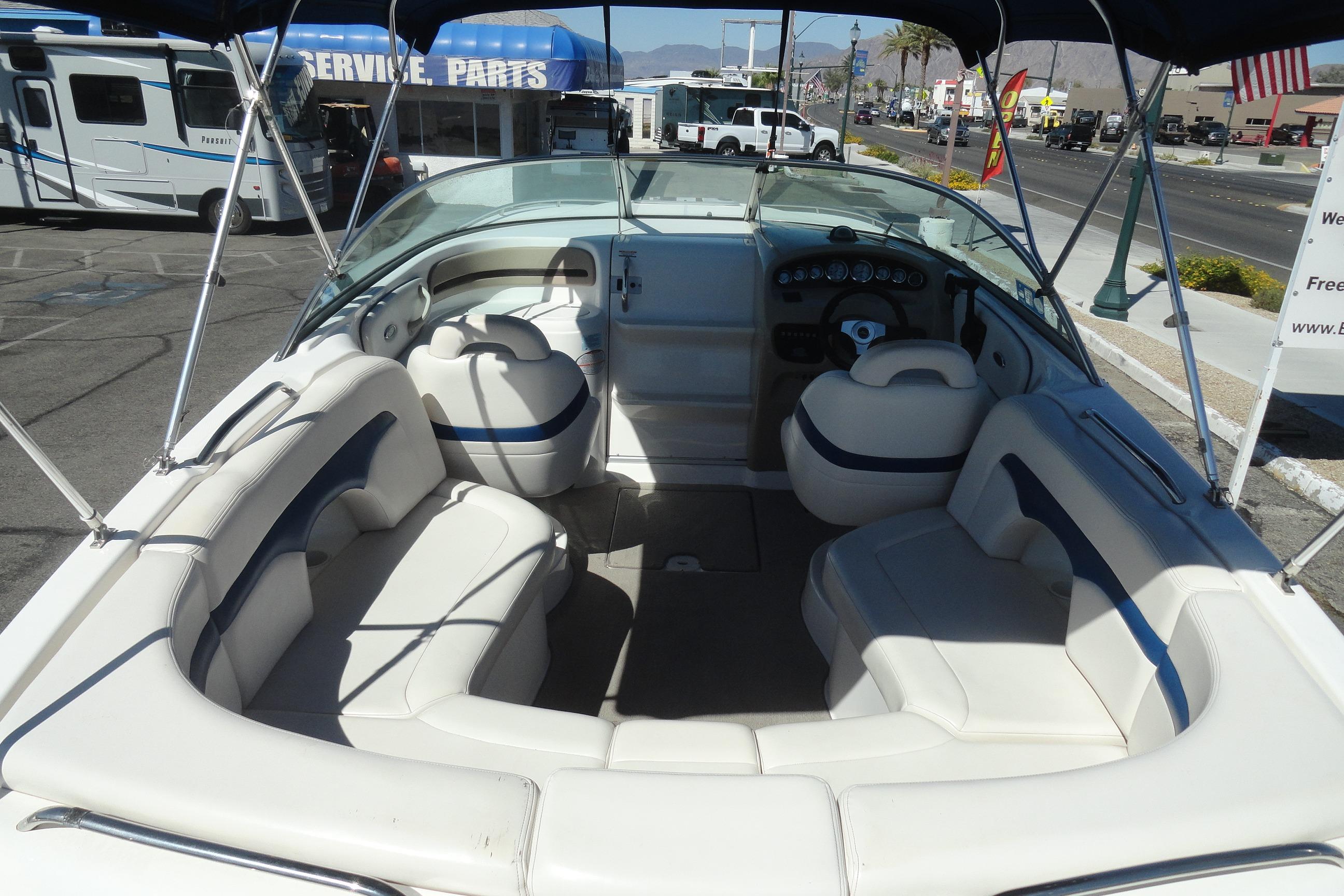 2001 Chaparral 265 SSi boat interior with white seating and steering console.