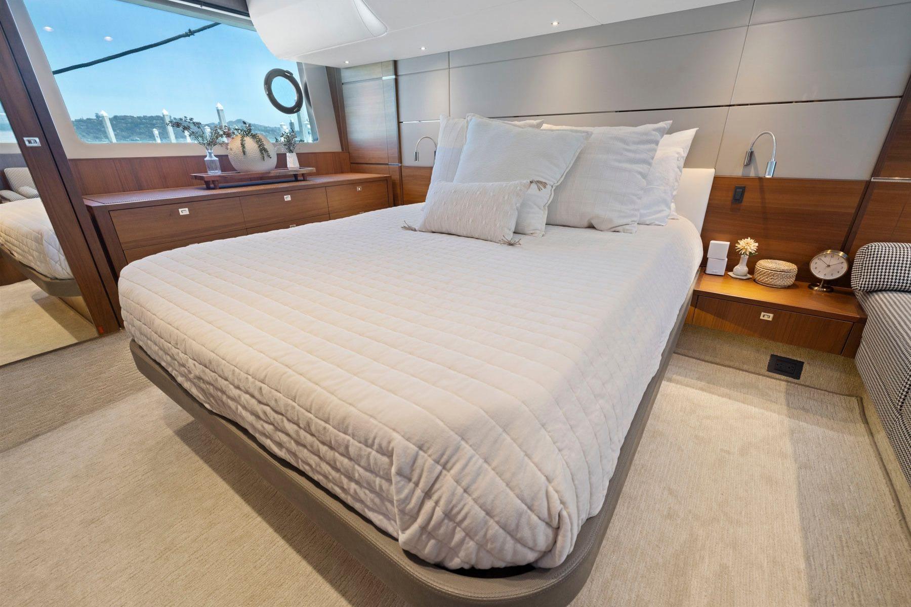 Luxurious bedroom interior of 2015 Princess 60 Flybridge Motor Yacht with elegant decor.