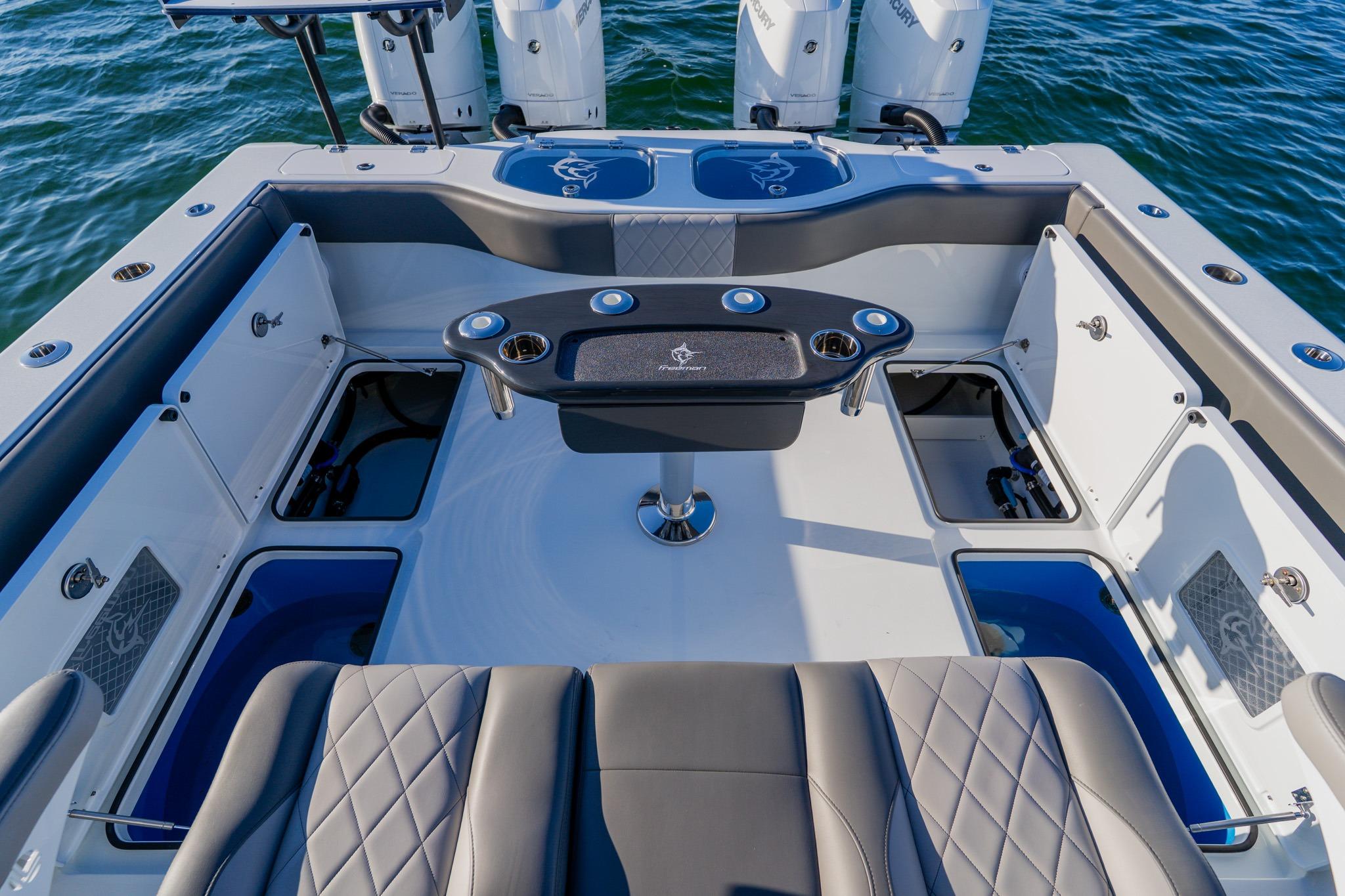 Freeman 42LR 2025 boat interior with seating and fishing equipment on water.