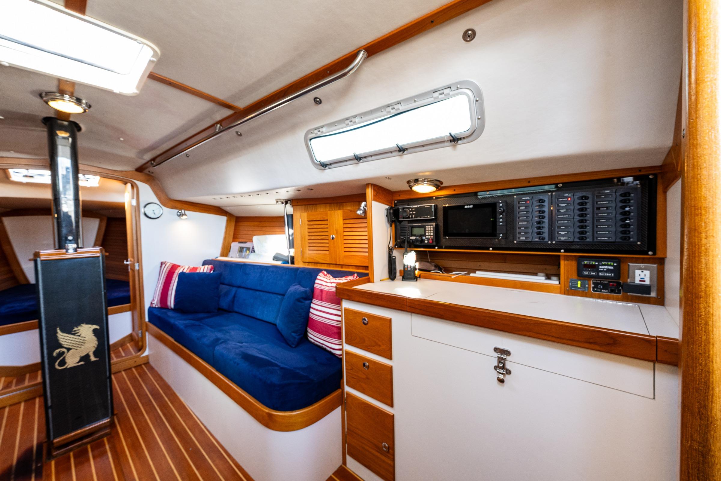 Interior of 2007 J Boats J/124 sailboat with blue seating and wooden accents.