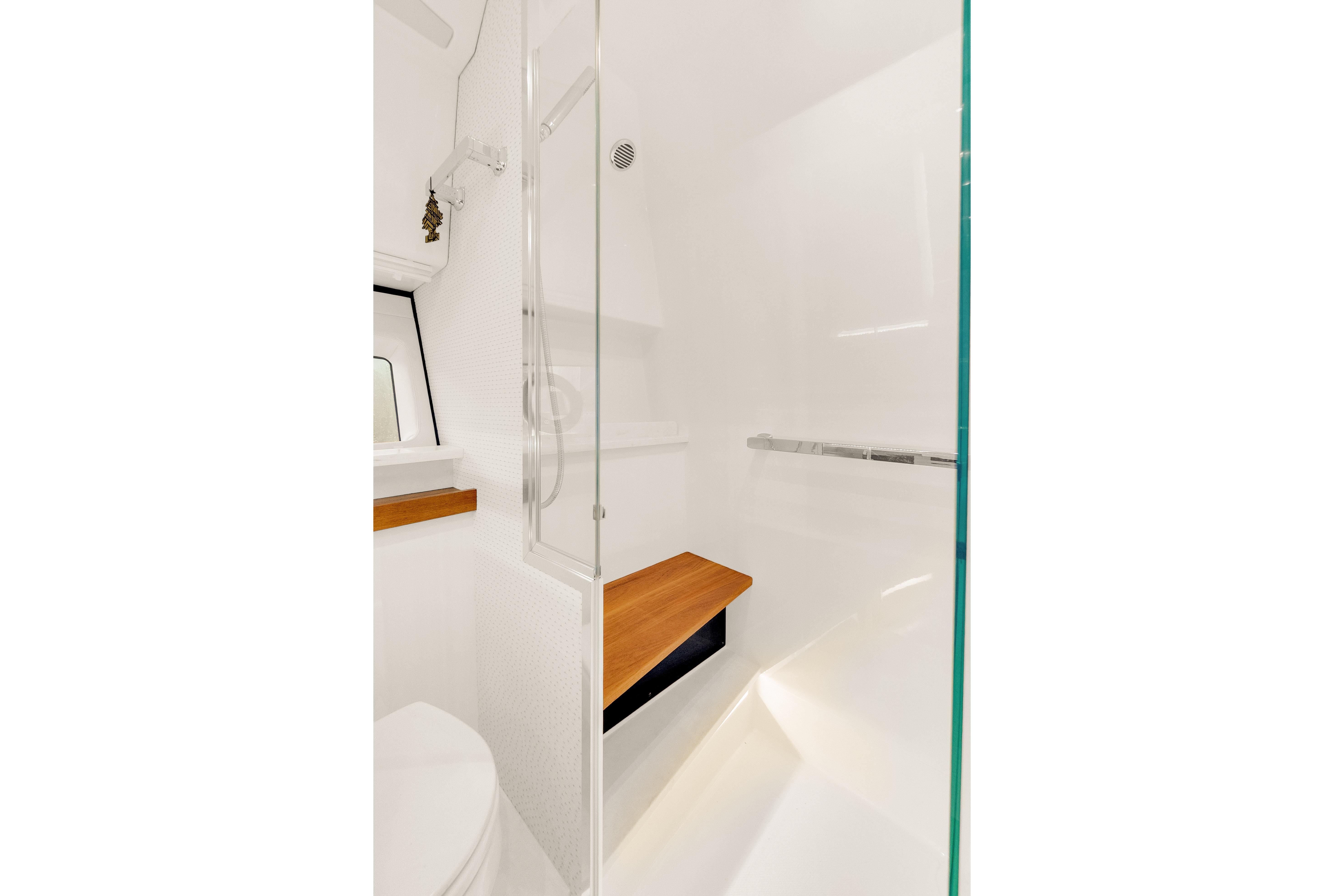 2021 Tiara Sport 43 LE yacht bathroom with modern shower and wooden accents.