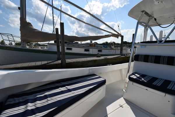 2021 Eastern 248 Center Console boat interior with striped seating at marina.