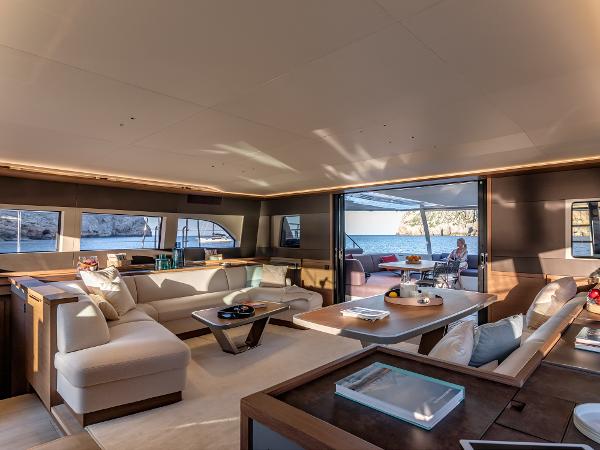 Luxurious interior of 2025 Lagoon SIXTY 7 yacht with spacious seating and ocean view.
