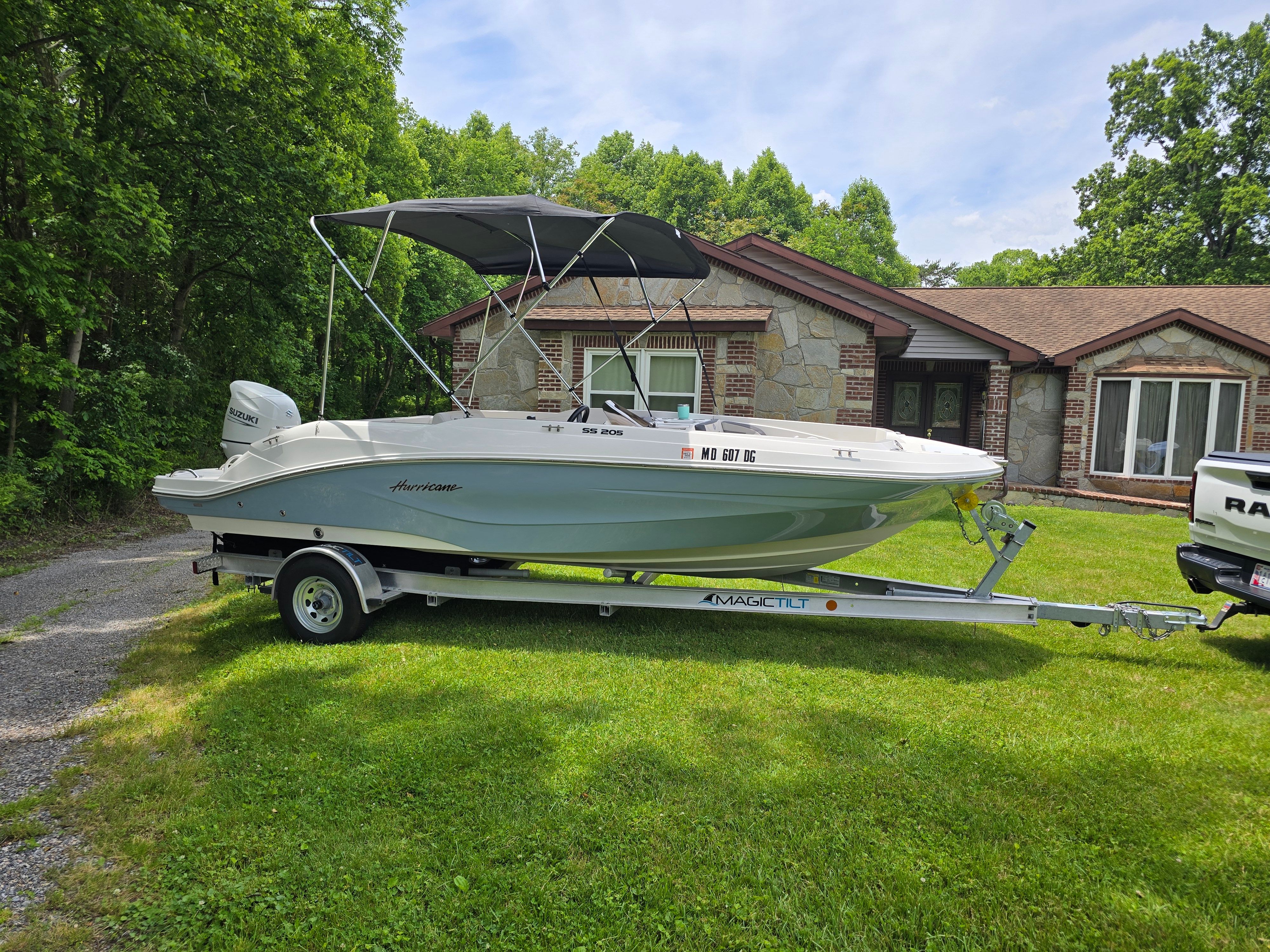 2021 Hurricane 205SS boat on trailer parked in front of house.