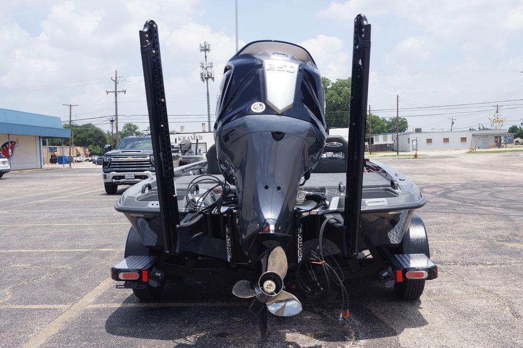 2027 Phoenix 921 Elite X II boat with powerful outboard motor in a parking lot.