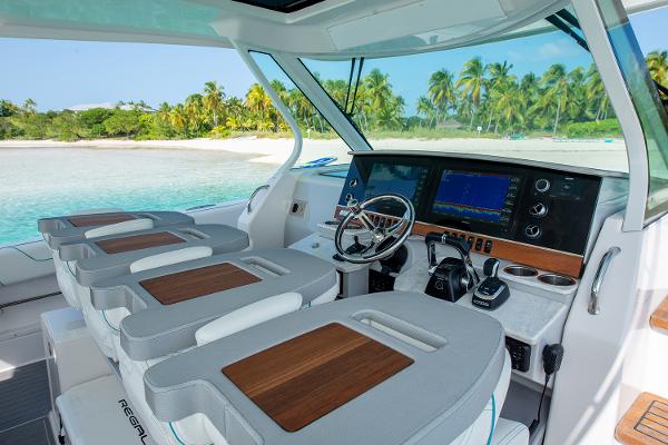 Manufacturer Provided Image: 2026 Regal 38 SAV yacht interior with modern dashboard and tropical beach view.
