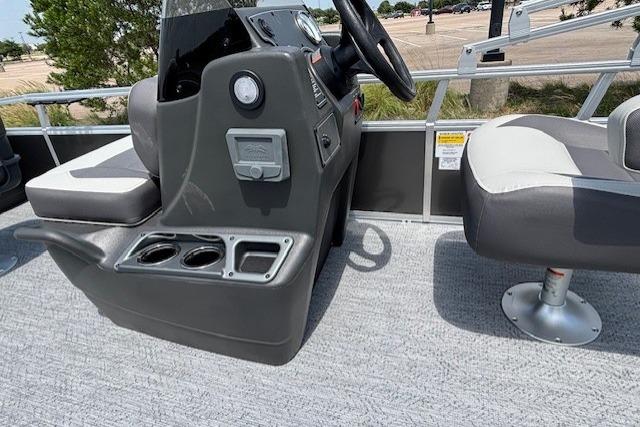 2026 Sun Tracker Bass Buggy 18 DLX boat interior with steering console and seating.
