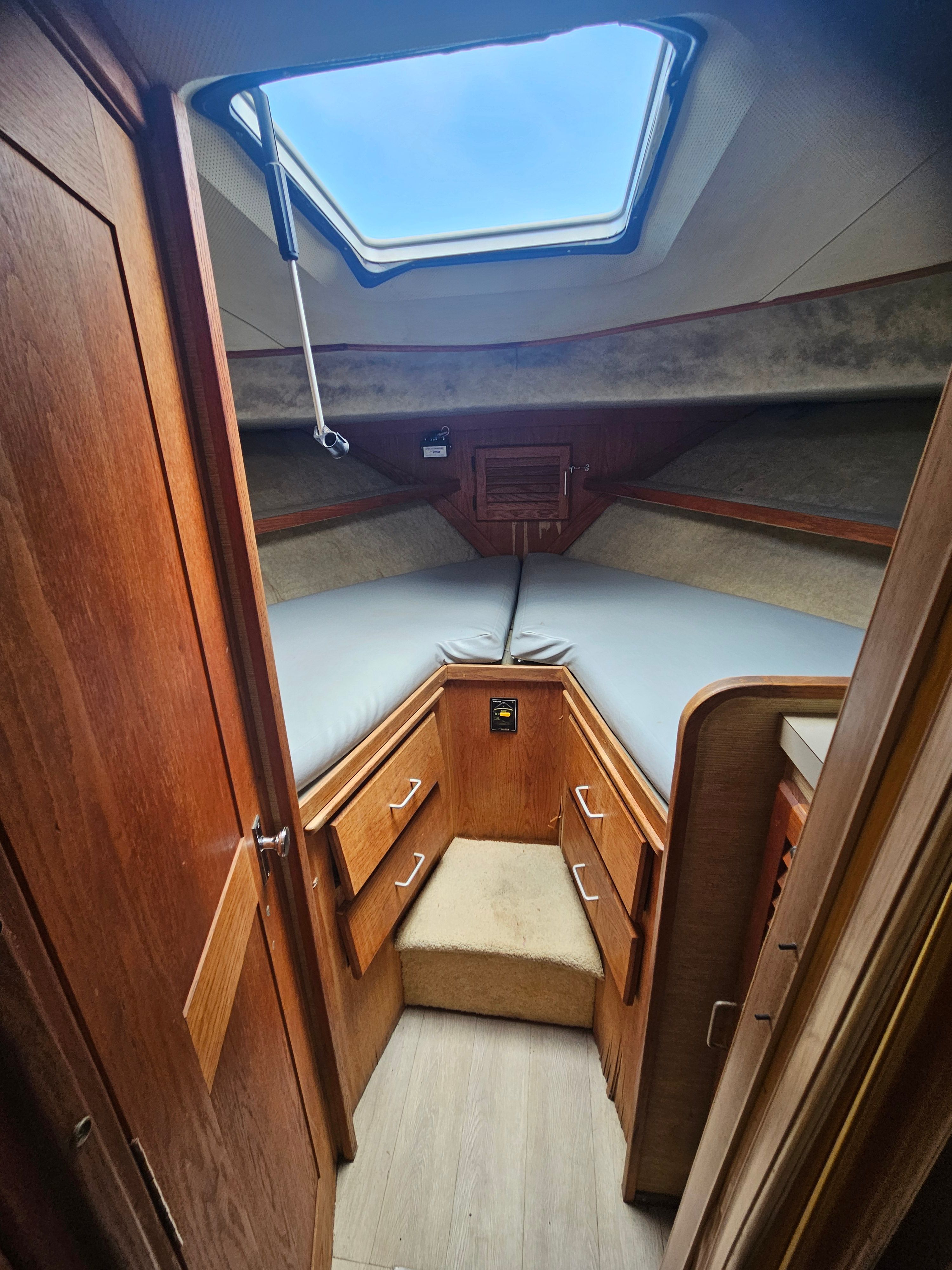 Interior of a 1984 Silverton 40 with wooden furnishings and skylights.