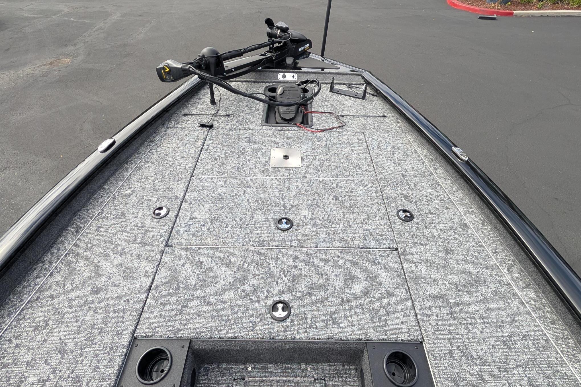 Front deck of a 2026 Tracker Pro Team 195 boat with fishing equipment.