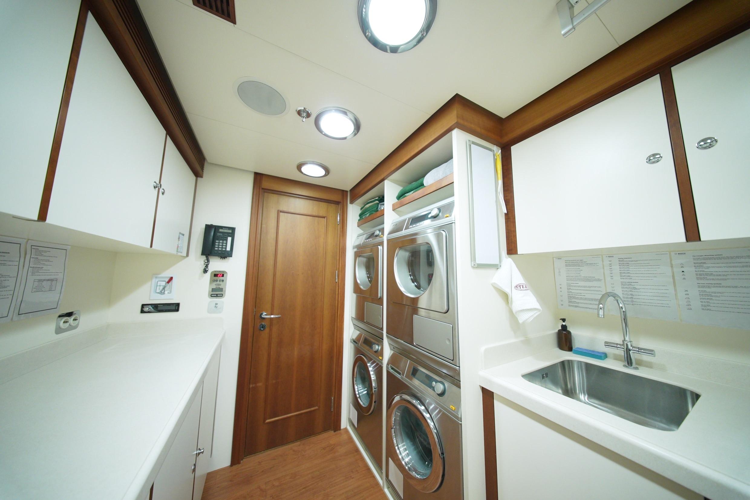 Laundry room on Pendennis 55 yacht, featuring modern appliances and sleek cabinetry, 2009 model.
