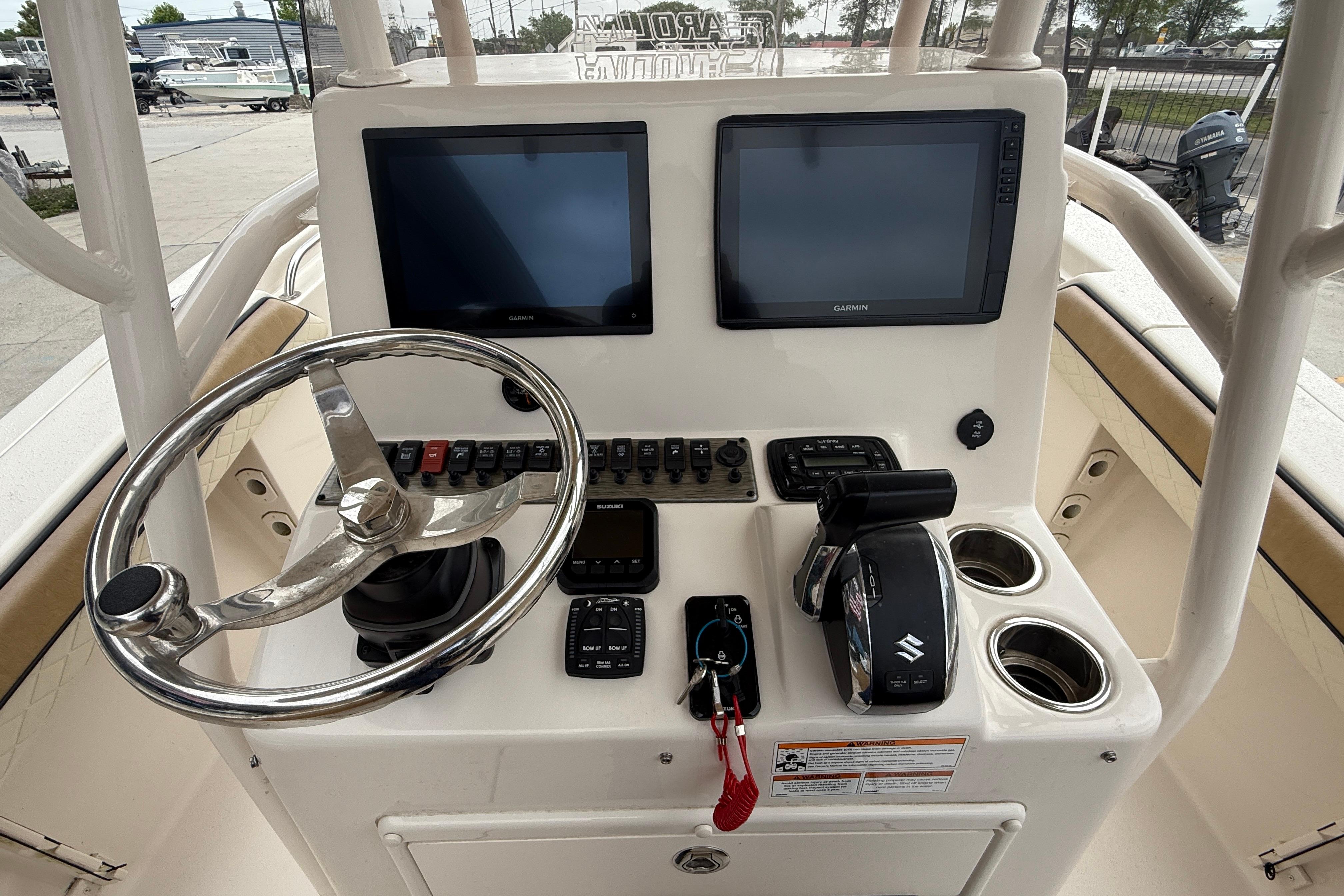 2023 SeaChaser 24 HFC boat console with dual screens, steering wheel, and controls.