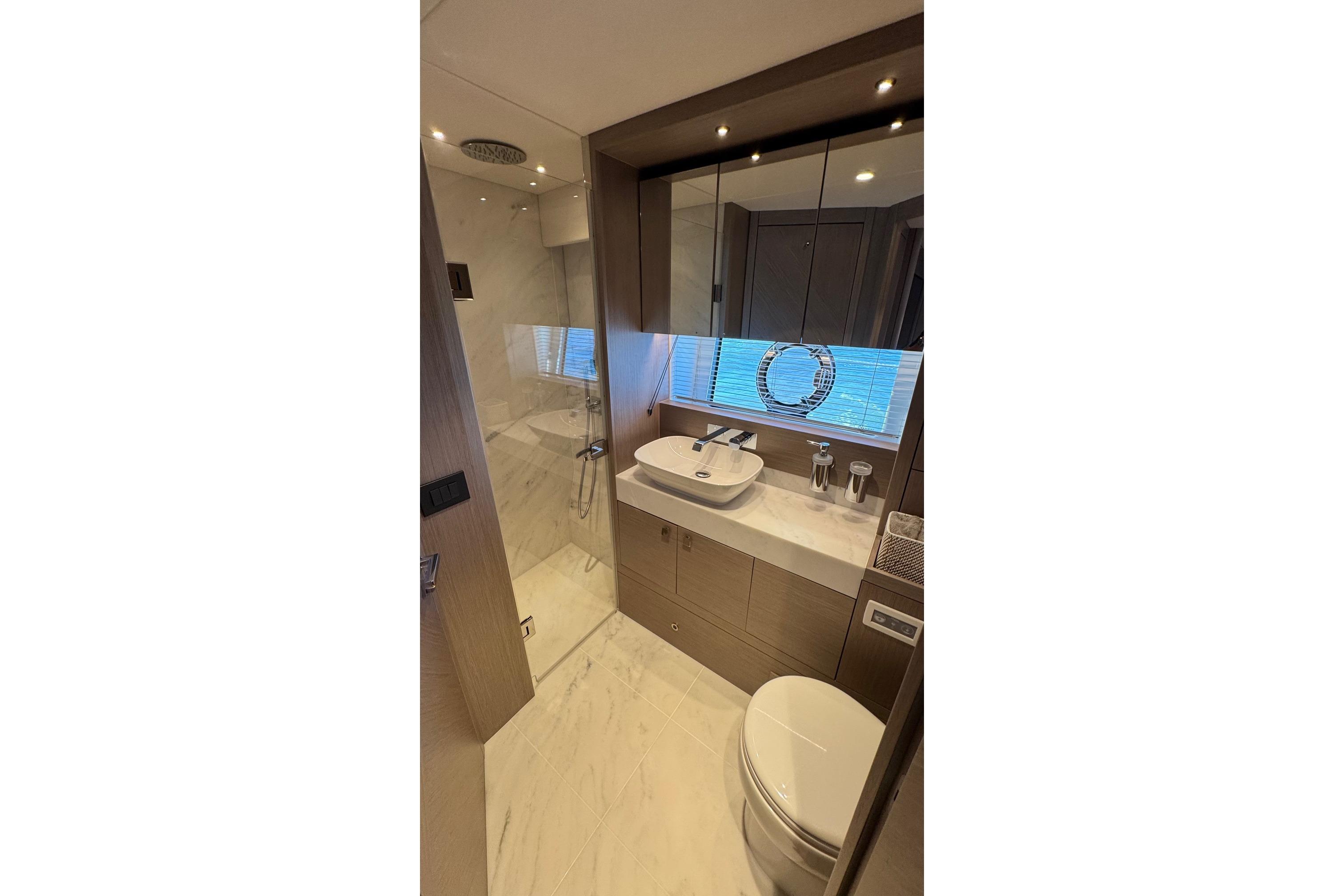 Luxurious bathroom in 2024 Sunseeker Manhattan 55 yacht, featuring modern fixtures and elegant design.
