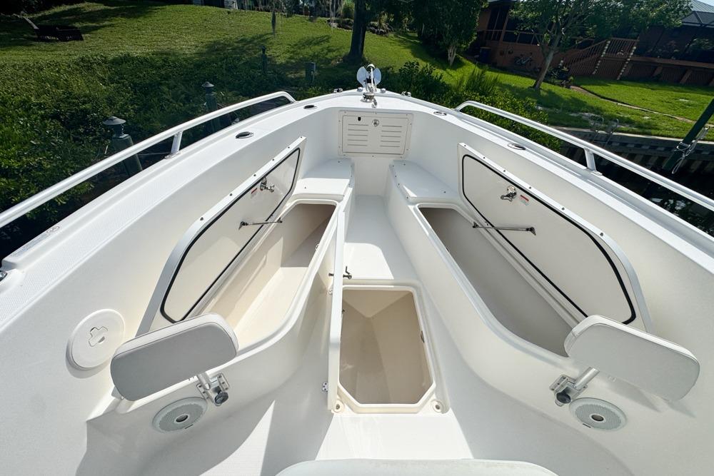 2018 Mako 284 Center Console boat with open storage compartments and sleek design.