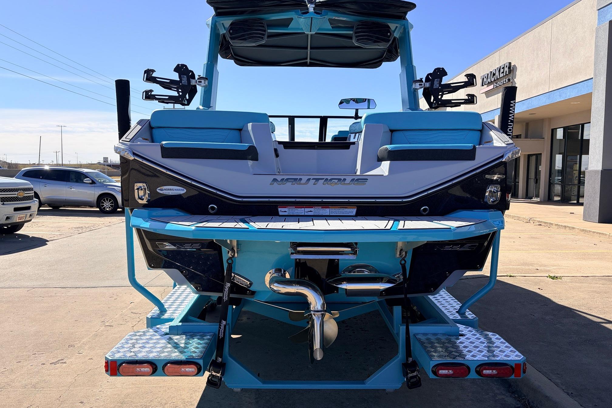2026 Nautique Super Air Nautique G23 boat, rear view, in a dealership lot.
