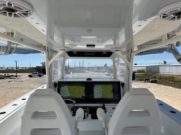 Interior view of a 2022 Freeman 42LR boat cockpit with dual navigation screens.