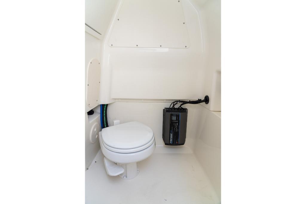 2024 Boston Whaler 280 Dauntless boat interior bathroom with toilet and equipment.