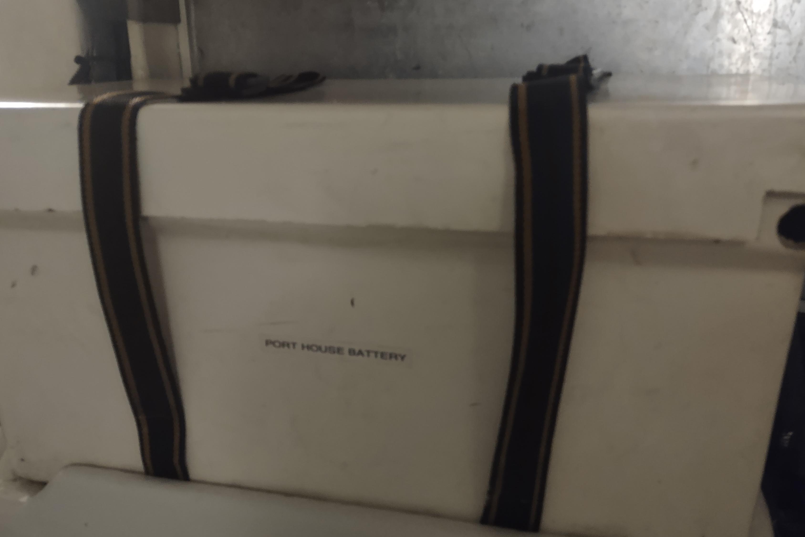 Port house battery in 2001 Kadey-Krogen 39 boat, secured with straps.