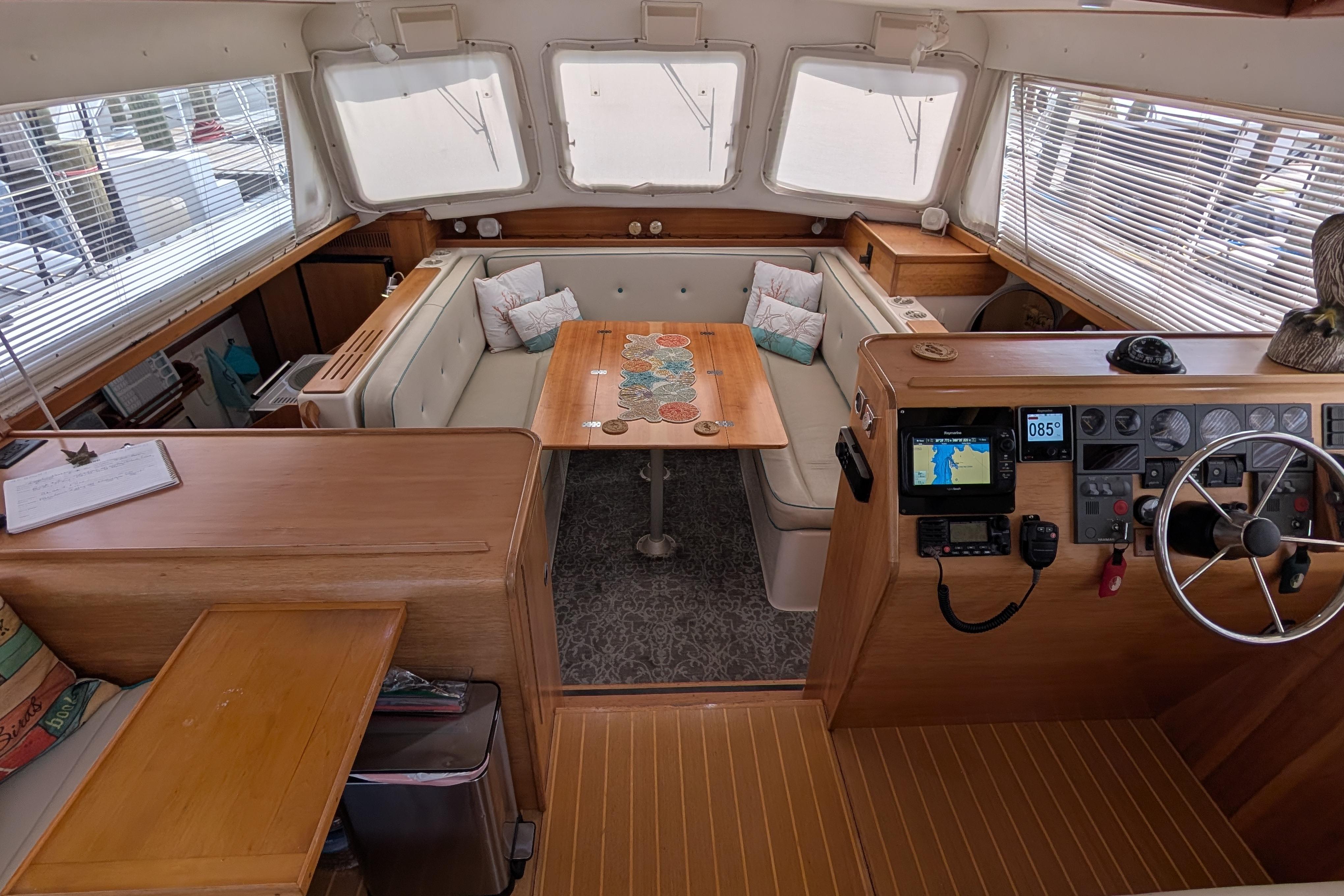 Interior of 2004 PDQ 34 Powercat, featuring helm, seating area, and navigation equipment.