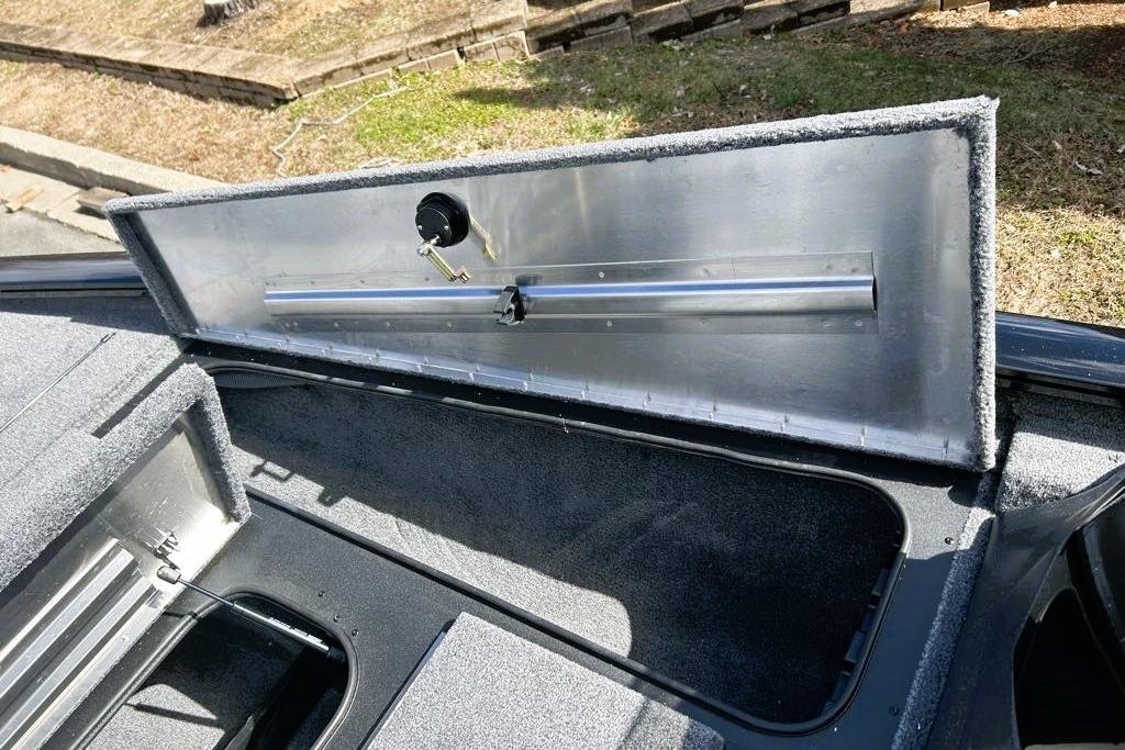 Open storage compartment of 2026 Tracker Pro Team 195 boat, showcasing interior details.