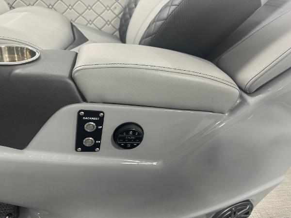 2025 Manitou LX boat interior with gray leather seats and control panel.