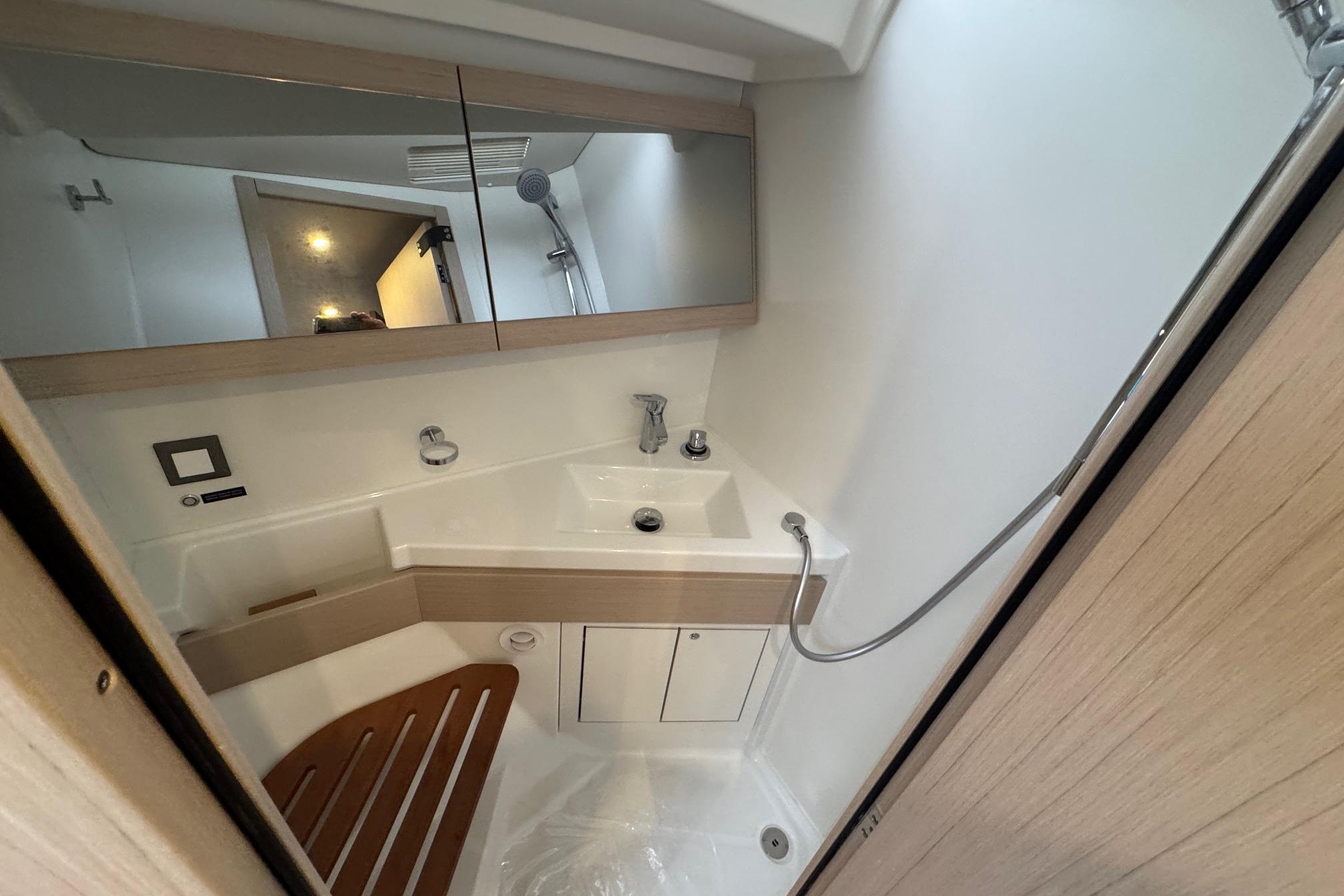 Modern bathroom in 2026 Beneteau Oceanis 46.1 yacht with sleek fixtures and wooden accents.