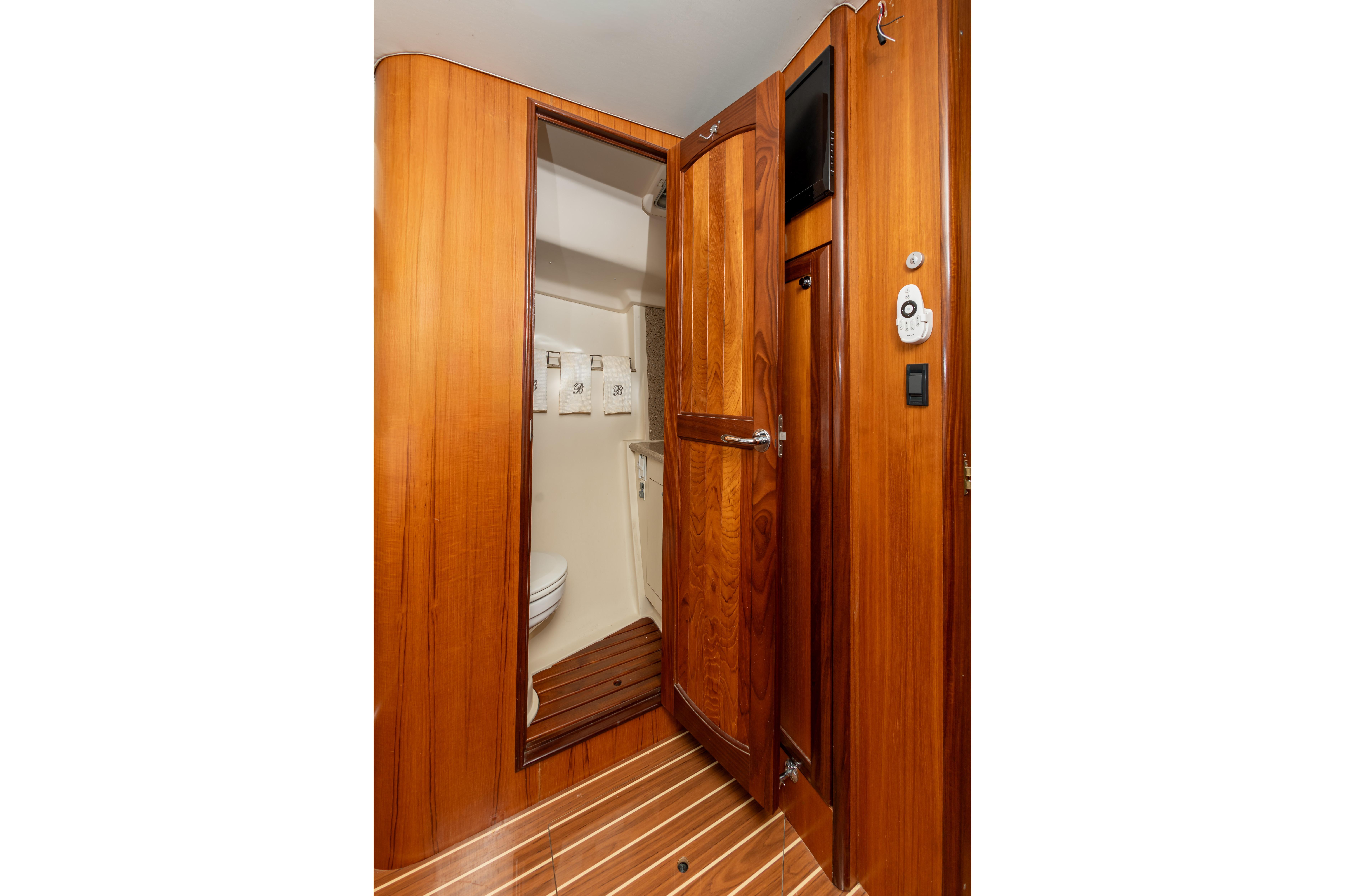 Interior of 2007 Hunter 49 yacht showing wooden door and bathroom area.