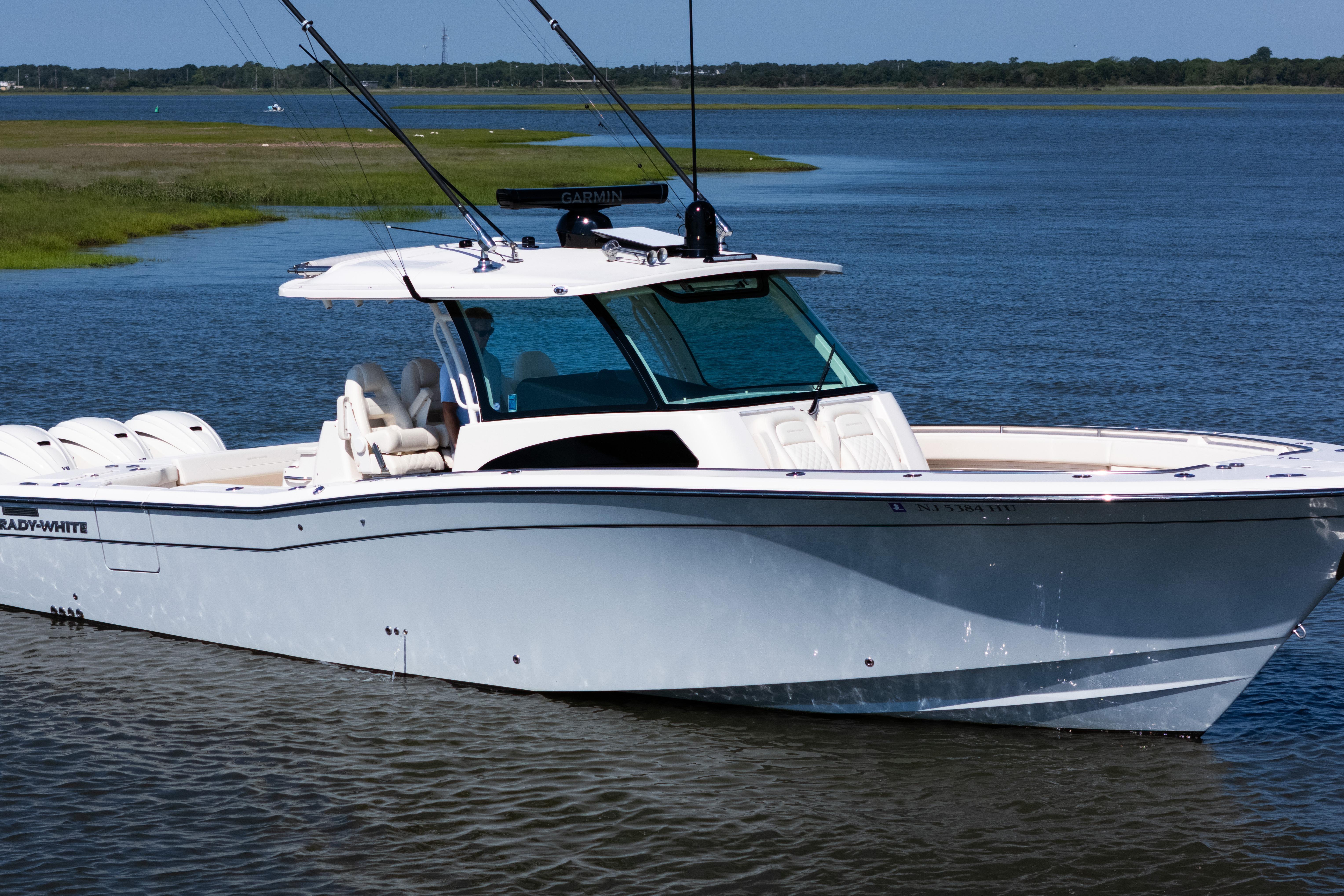 2025 Grady-White Canyon 386 boat on calm water, showcasing sleek design and advanced features.