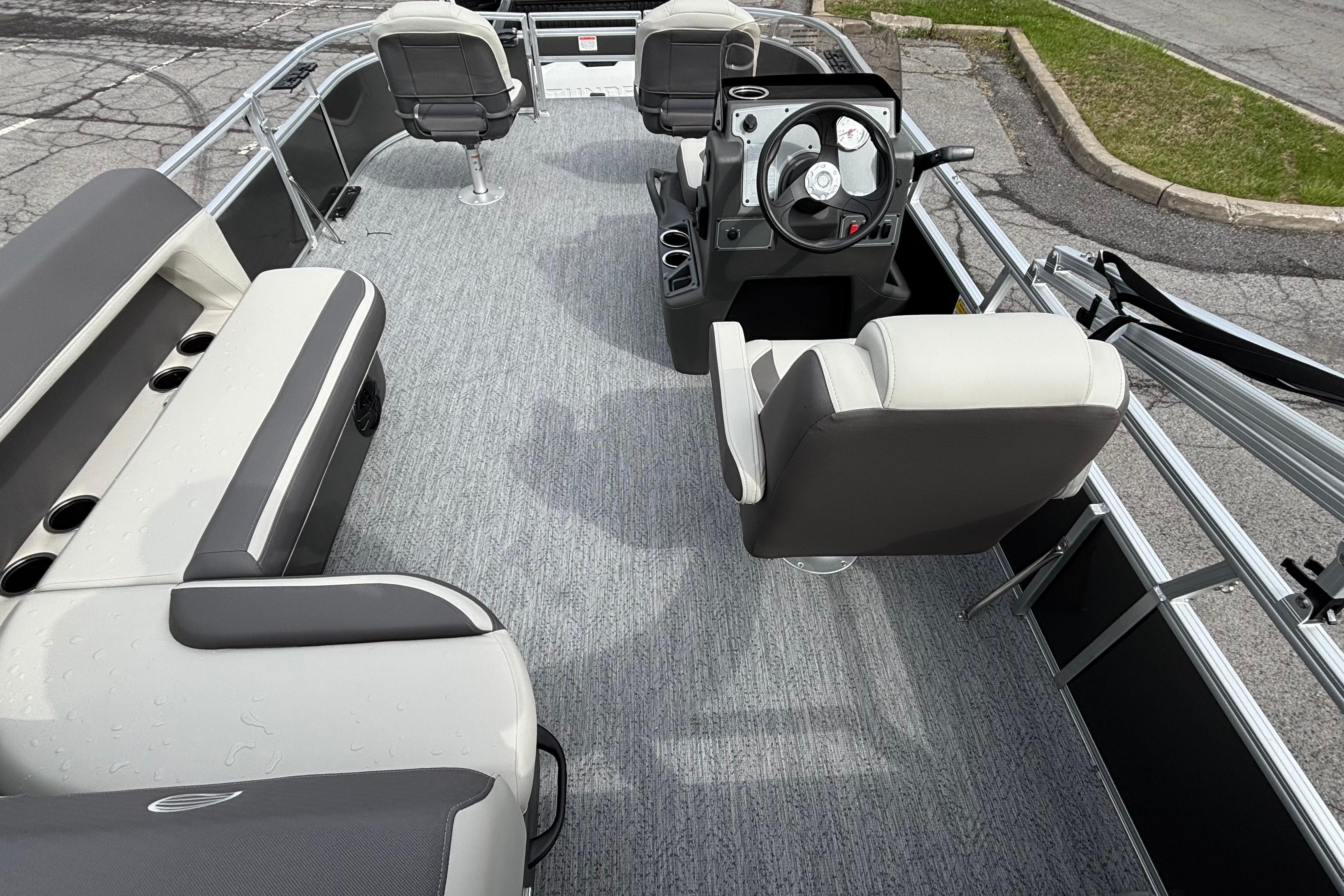 2026 Sun Tracker Bass Buggy 16 XL Select pontoon boat interior with seating and steering console.