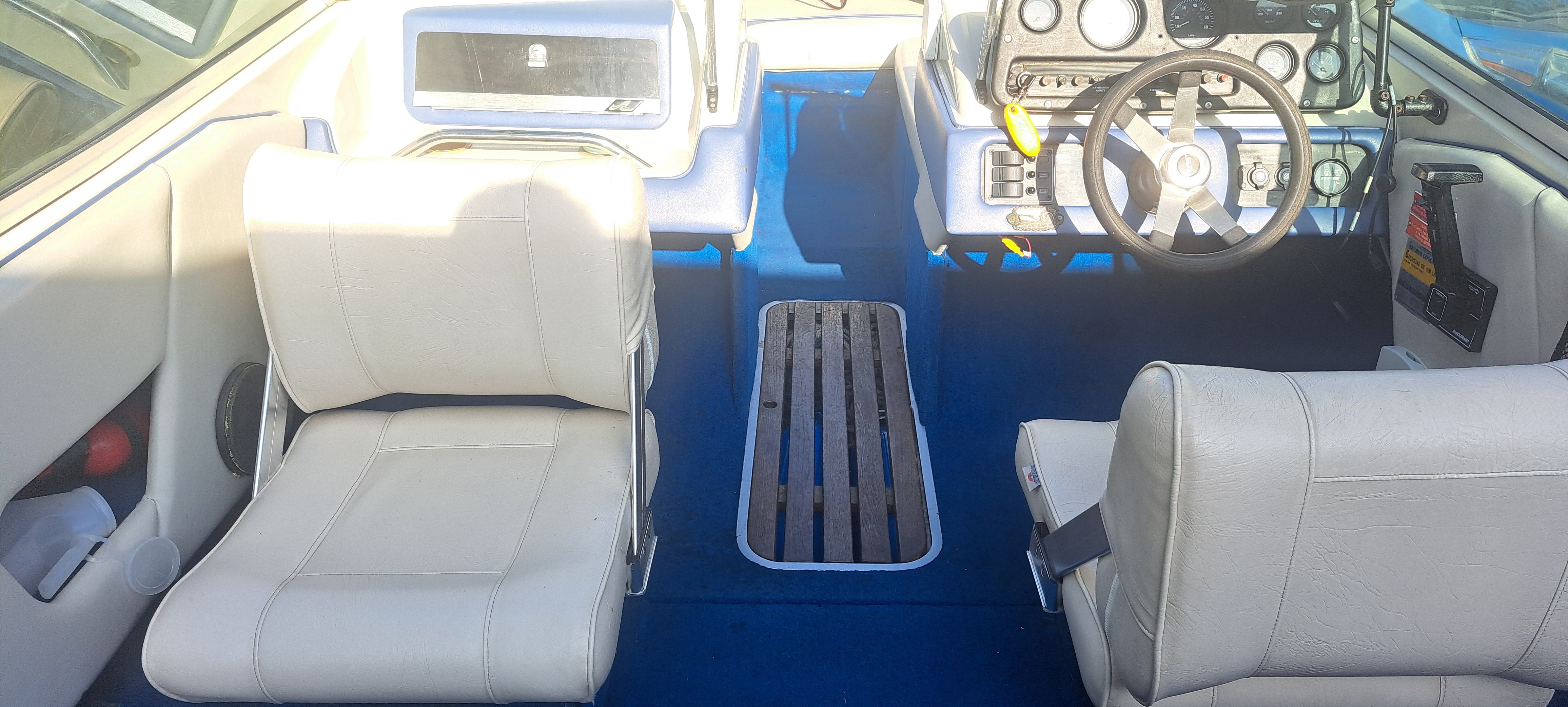Interior of a 1988 Sea Ray Seville boat with white seats.