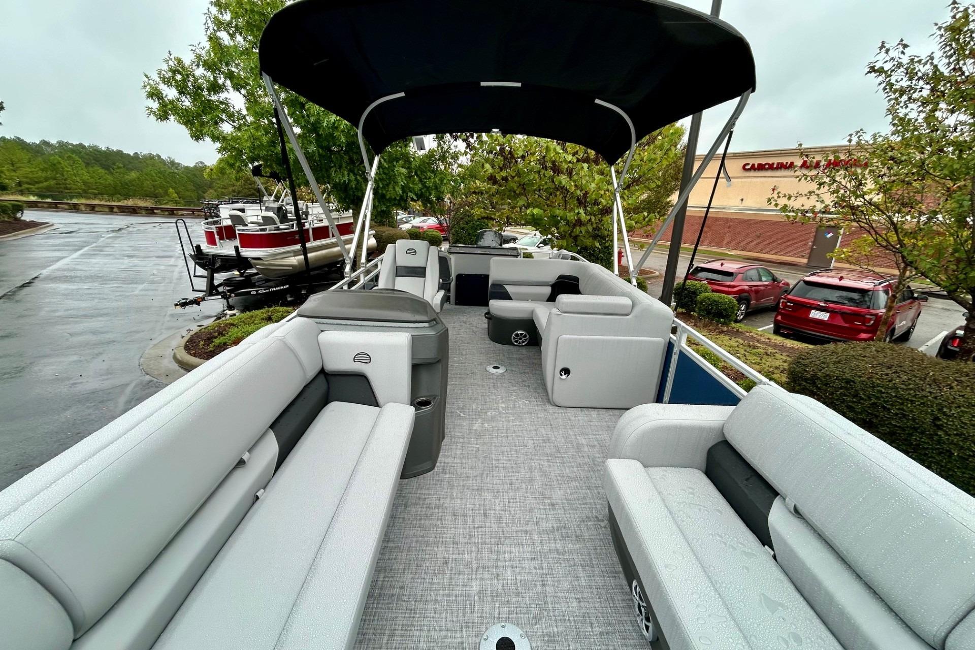 2026 Sun Tracker SportFish 22 DLX pontoon boat with spacious seating and canopy.