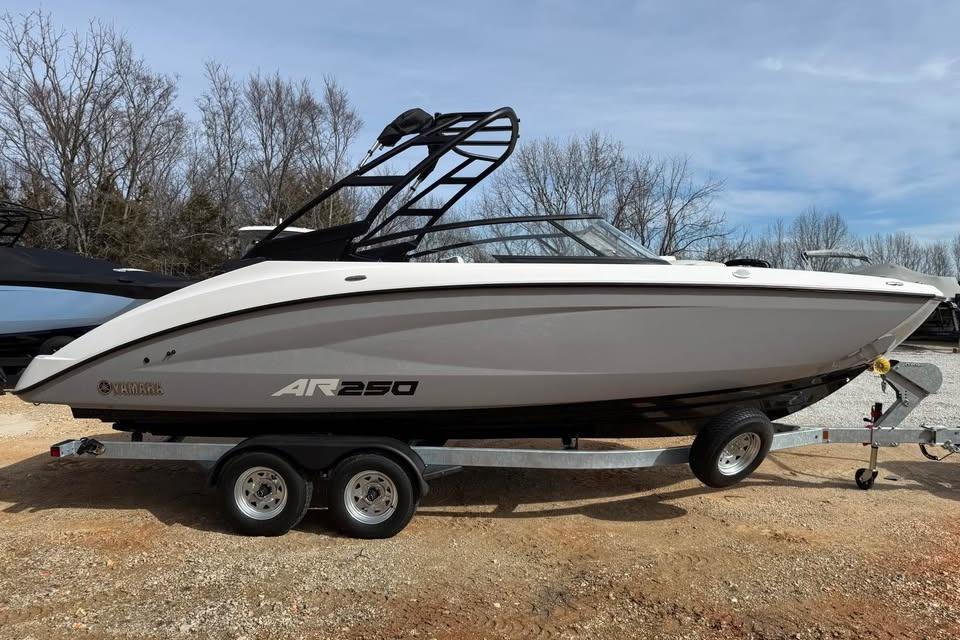 2026 Yamaha Boats AR250 on trailer, parked outdoors, showcasing sleek design and modern features.