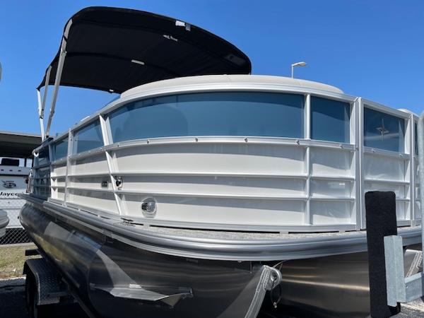 2025 Berkshire 22 RFX LE Tri-toon Pontoon with canopy, docked under clear blue sky.