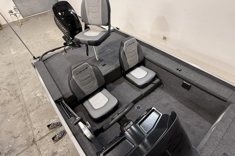 2026 Lowe Skorpion 16 boat interior with three gray seats and steering console.