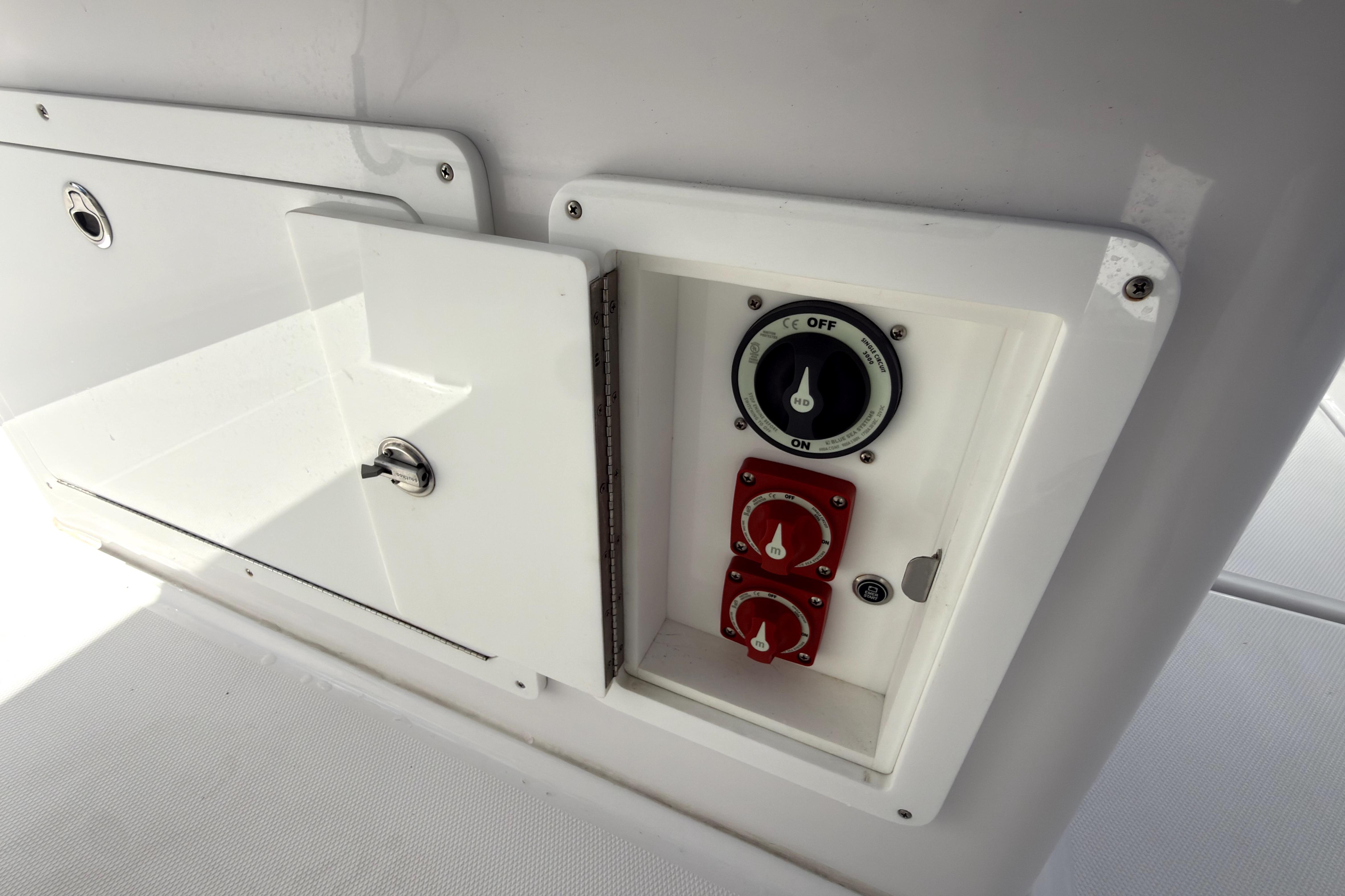 Control panel on a 2023 Bertram 28 CC boat, featuring switches and dials.