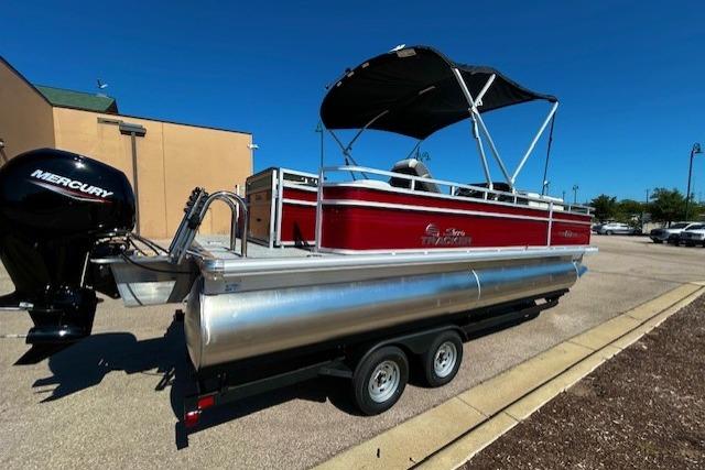 2026 Sun Tracker Fishin' Barge 22 DLX pontoon boat on trailer, red exterior, Mercury outboard motor.