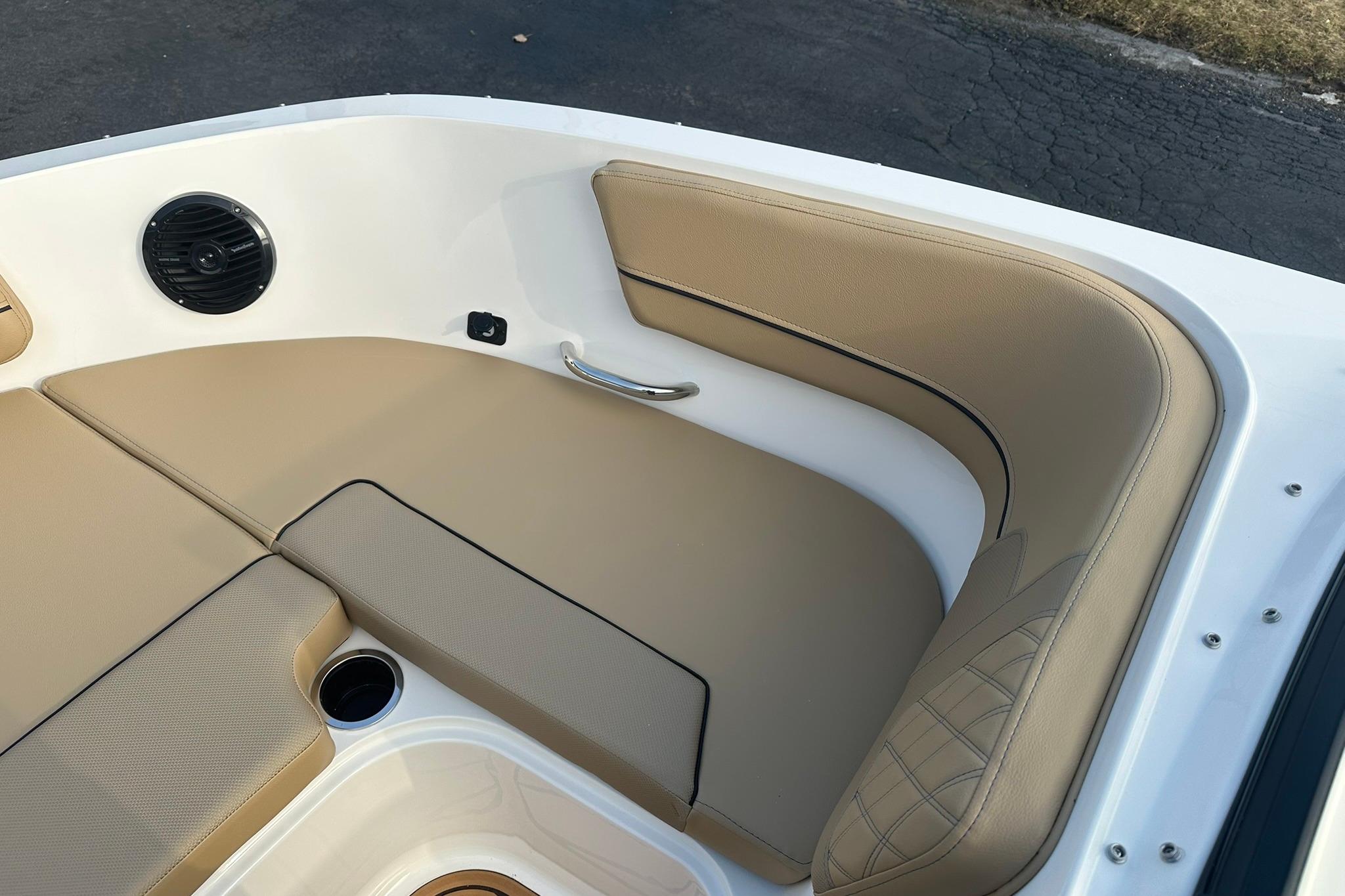 2026 Bayliner VR6 Bowrider OB interior with tan seating and speaker detail.